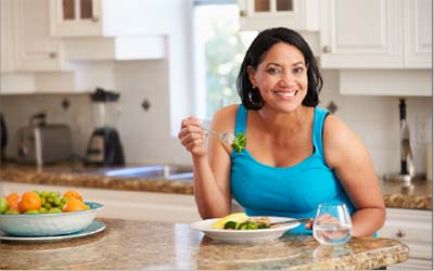 Woman happily eating healthy food